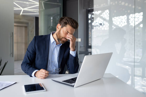 Frustrated business owner looking at his laptop